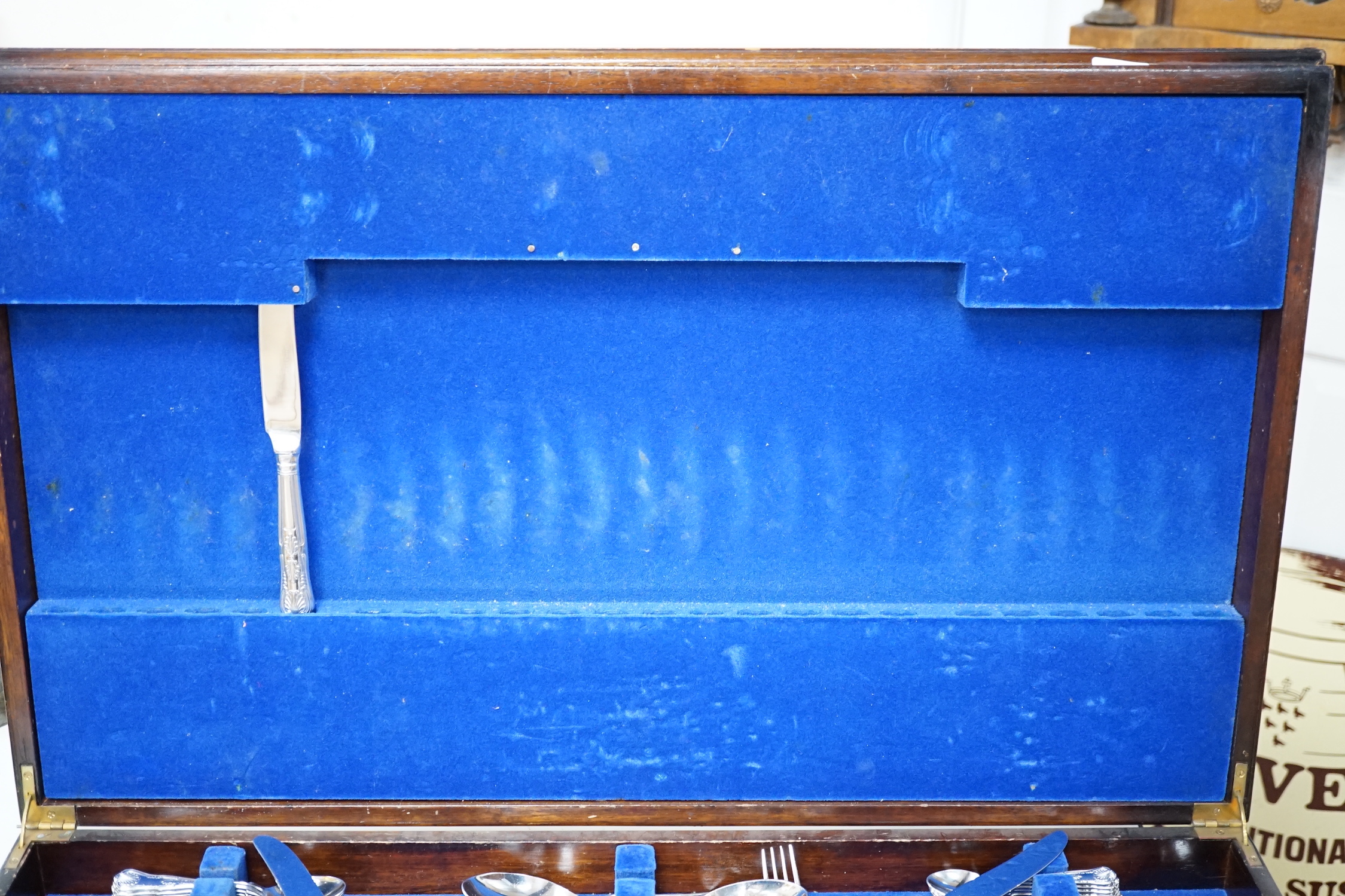 A canteen of plated cutlery with tooled leather top, 77cm wide